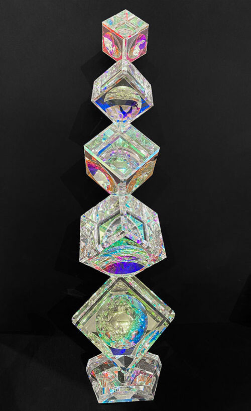 5 Tumbling Crystal Cubes by Harold Lustig. Lustig creates stunning crystal cubes with a dichroic film. This film refracts light and color and creates stunning rainbow colors.