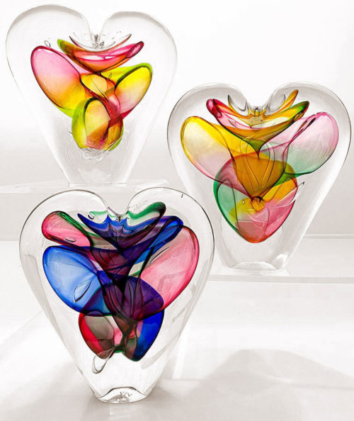 three colorful crystal heart sculptures