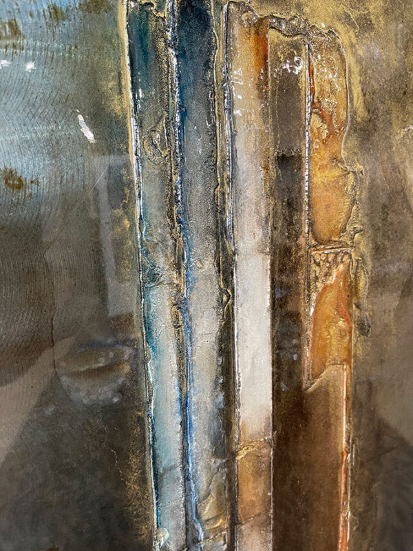 Abstract, metal, wall sculpture with blue, grey, and gold.