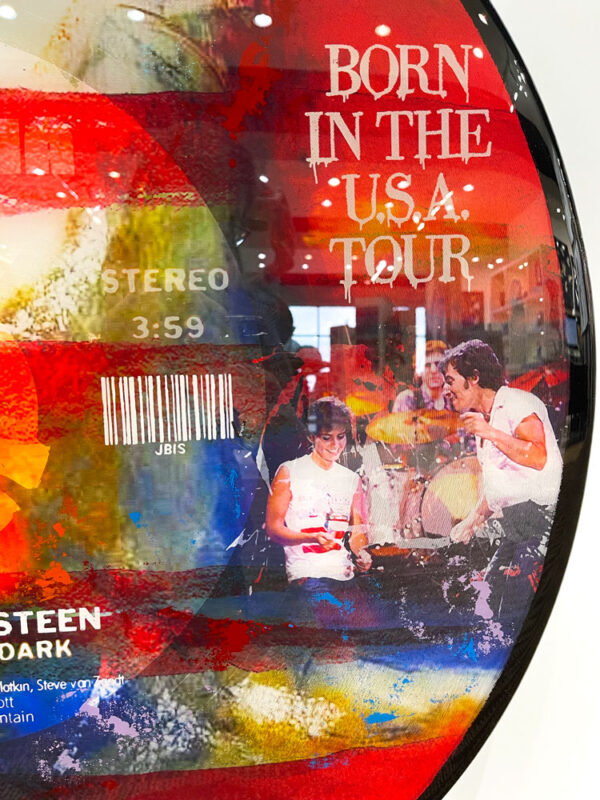 Dancing in the Dark - Bruce Springsteen by The Bisaillon Brothers. This Pop Artwork is a mixed media piece of Bruce Springsteen during the Born in the USA tour. Record shape canvas with american flag background. Bruce Springsteen Dancing in the Dark record.