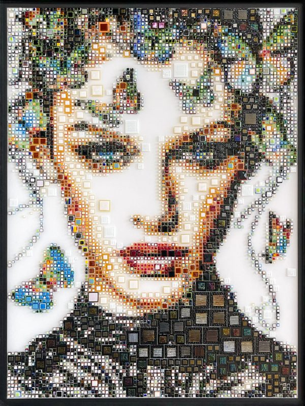 Elektra by Isabelle Scheltjens. Pieces of glass in different colors, sizes, and textures are melted together and applied like dots of paint used by pointillists to create Pop art portraits of modern celebrities, icons, and female faces. Ekektra was inspired by Brazillian model Gisele Bündchen.