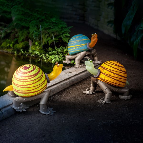 Arnold Turtle Outdoor light in three colors: yellow, blue, and lime green. glass light sculpture with metal feet