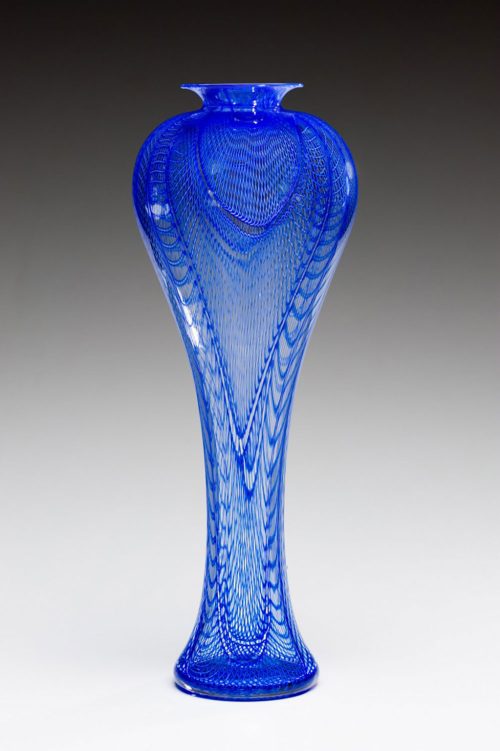 Blue Narcissus vessel from the Diva Series by American glass artist Kenny Pieper. 20 inch tall glass vessel with intricate cobalt blue linework.