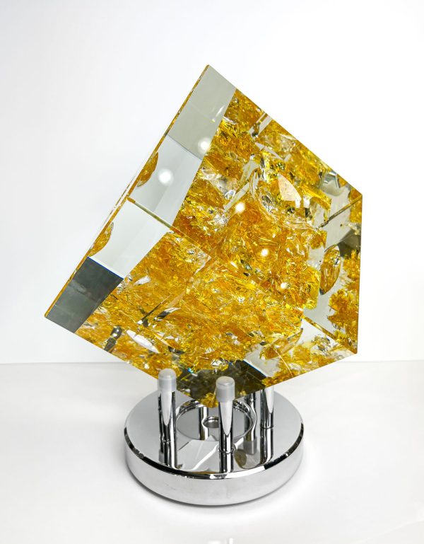Gold Balos Cube on Turntable Base by Jeff Honsberger. Crystal cube with gold gridded color on the interior.