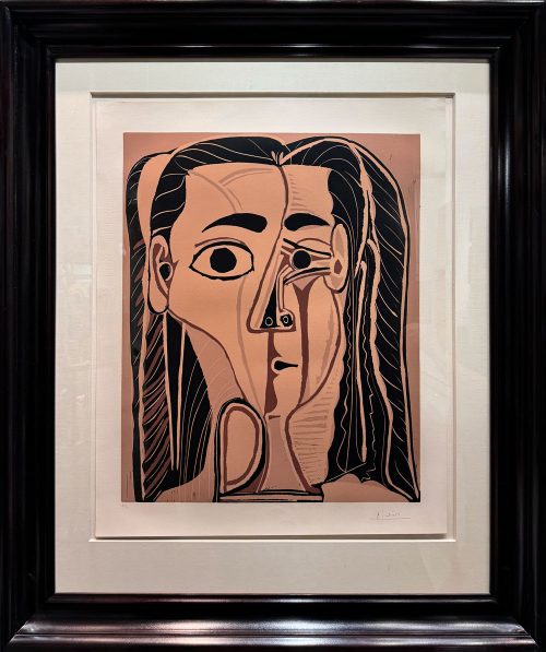 Jacqueline au Bandeau de Face (Grand Tête de Femme), 1962 by Pablo Picasso. Jacquline with a Headband (Large Woman's Head). Framed linocut of Jacqueline Roque, Picasso's misstress and second wife. The print is on woven arches paper, and is signed & numbered on the bottom. An abstract portrait of a woman by Pablo Picasso framed in a dark black frame.